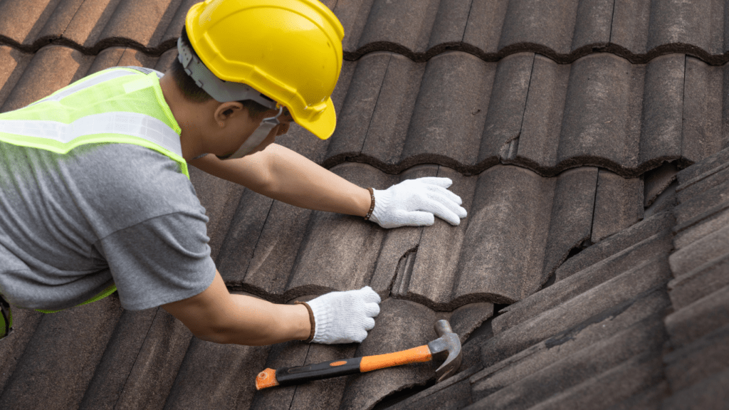 A man repairing a roof with a hammer