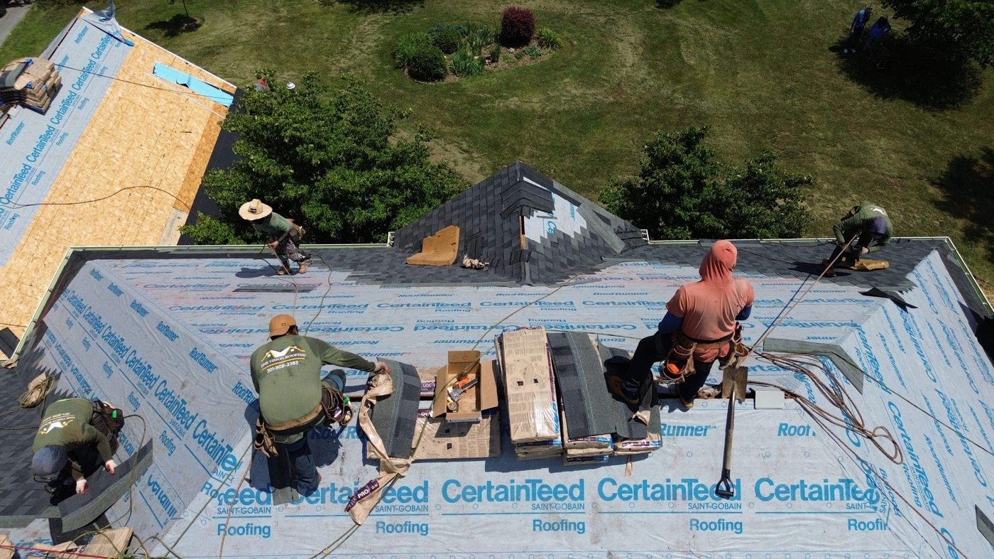 One Vision Roofing crew working on an exposed roof deck during a replacement