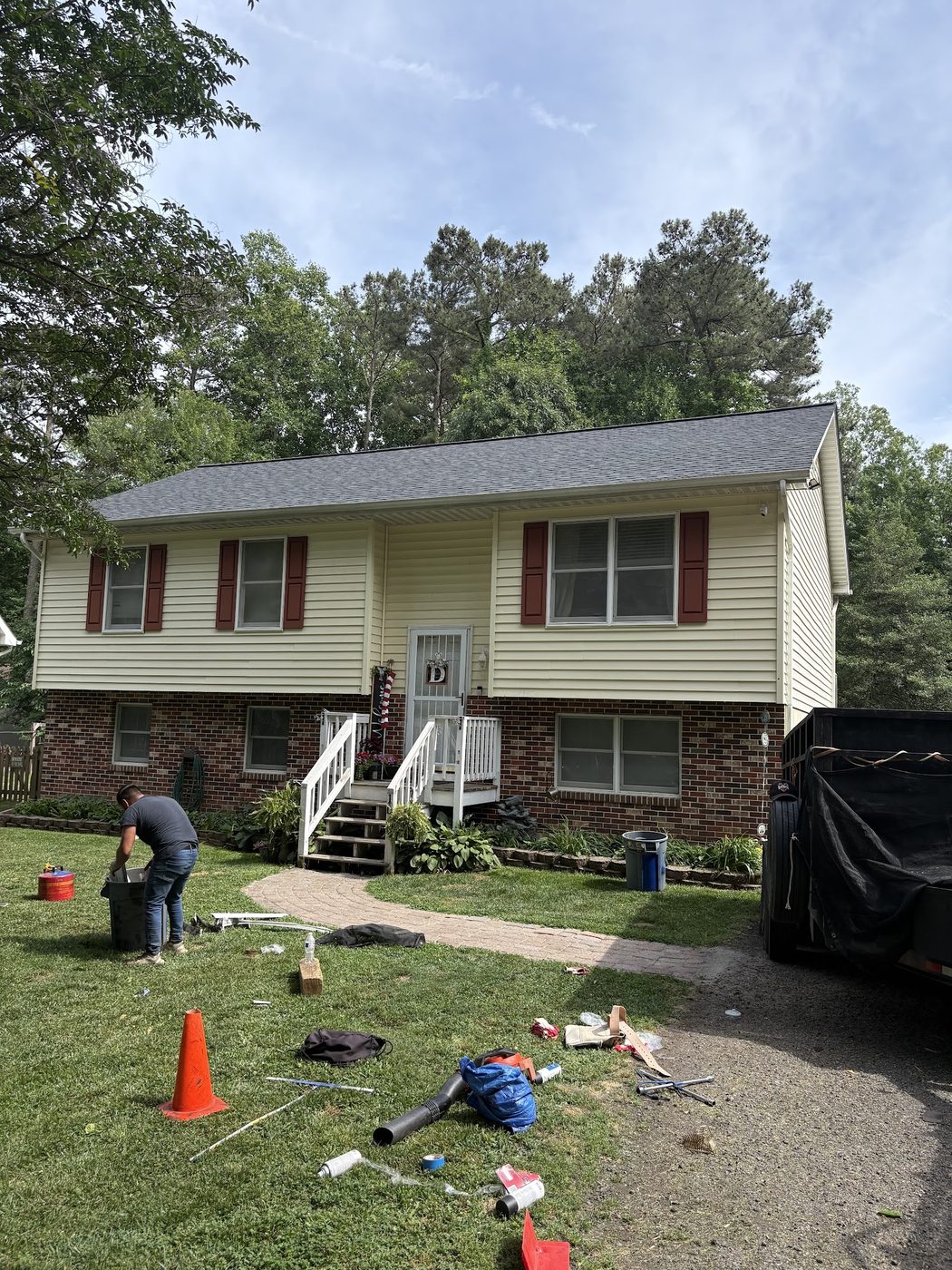 Roofing crew member working in the yard during a roof job