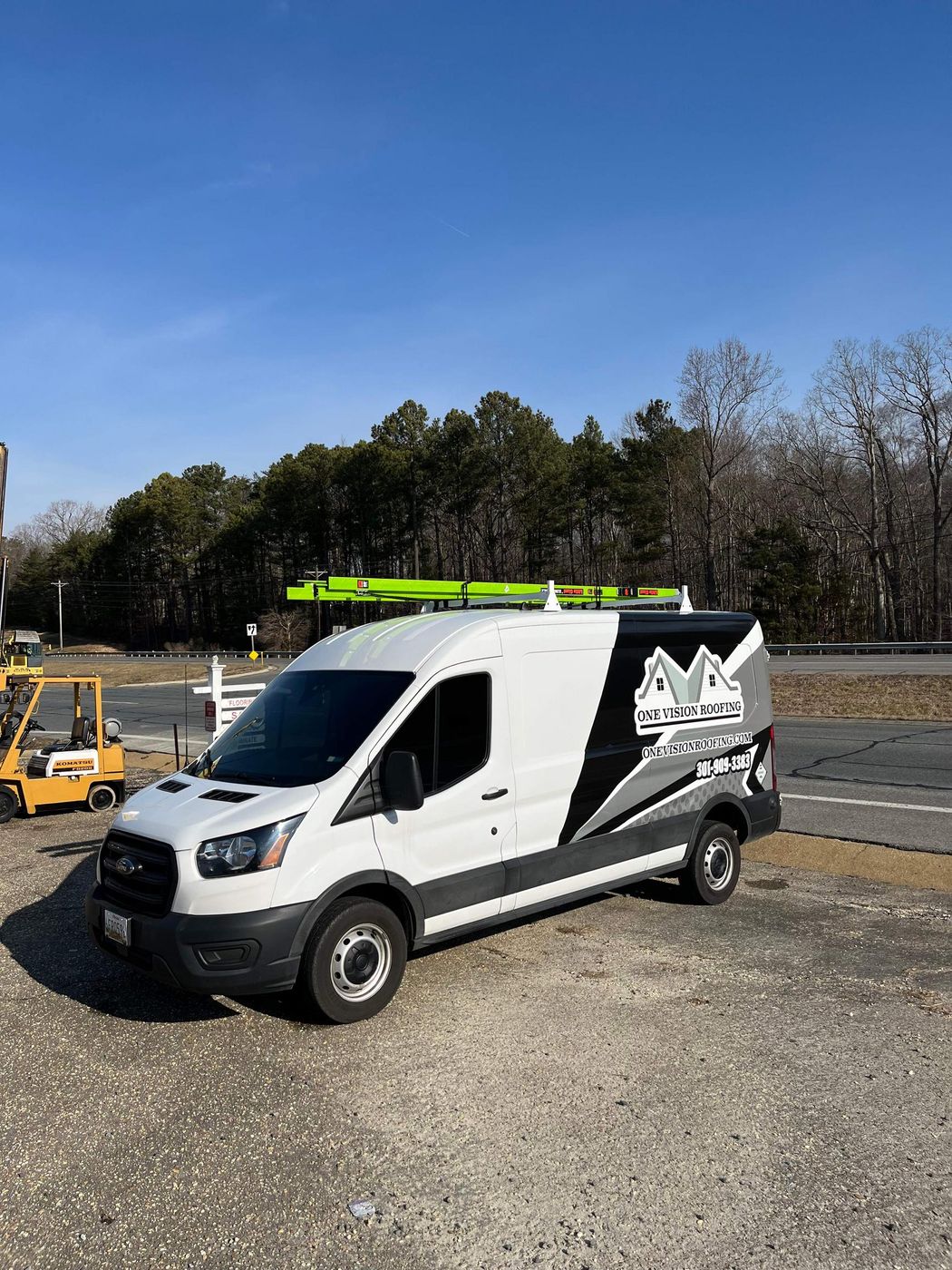 One Vision Roofing work van with ladders