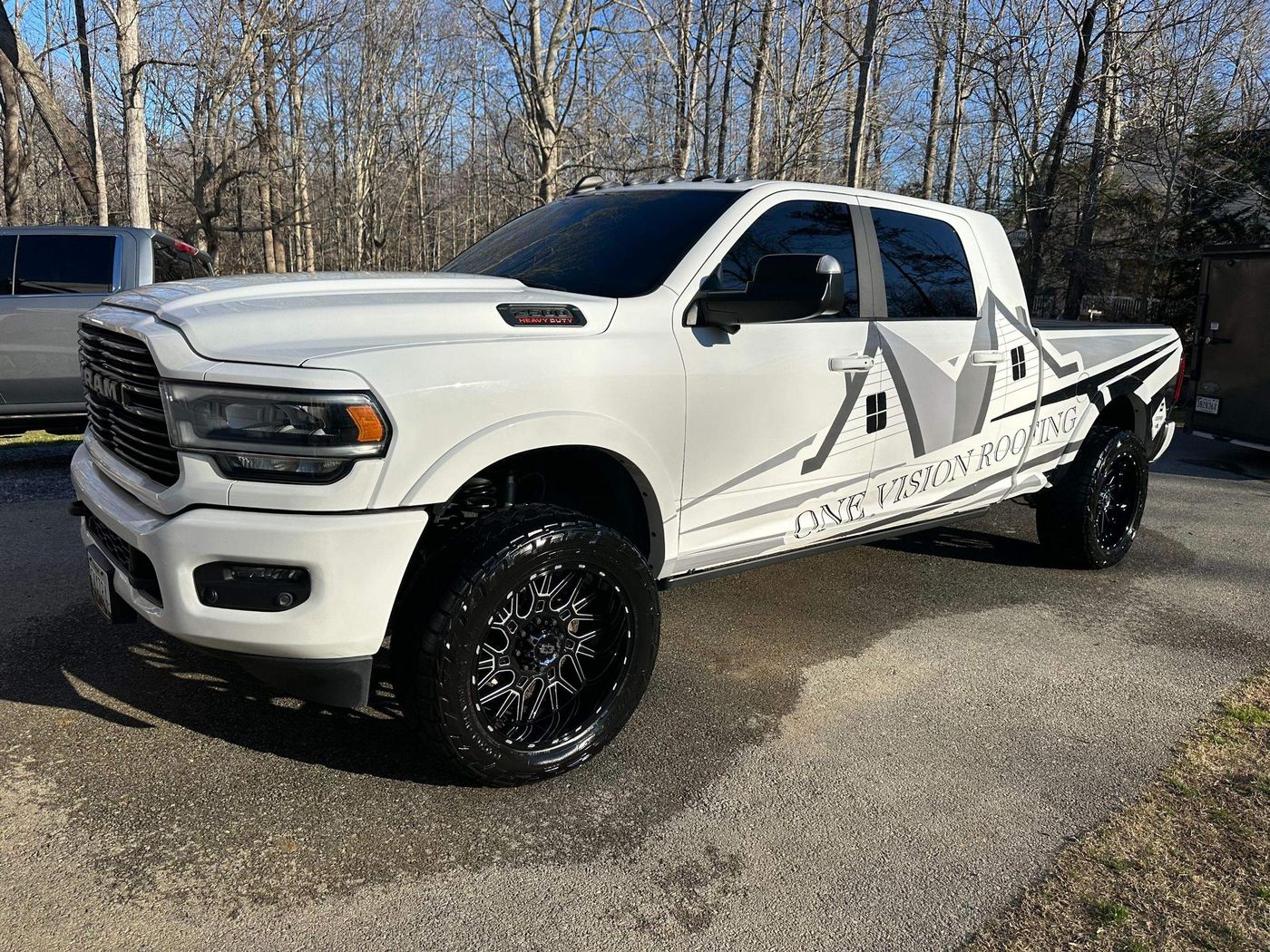White One Vision Roofing pickup truck with company graphics