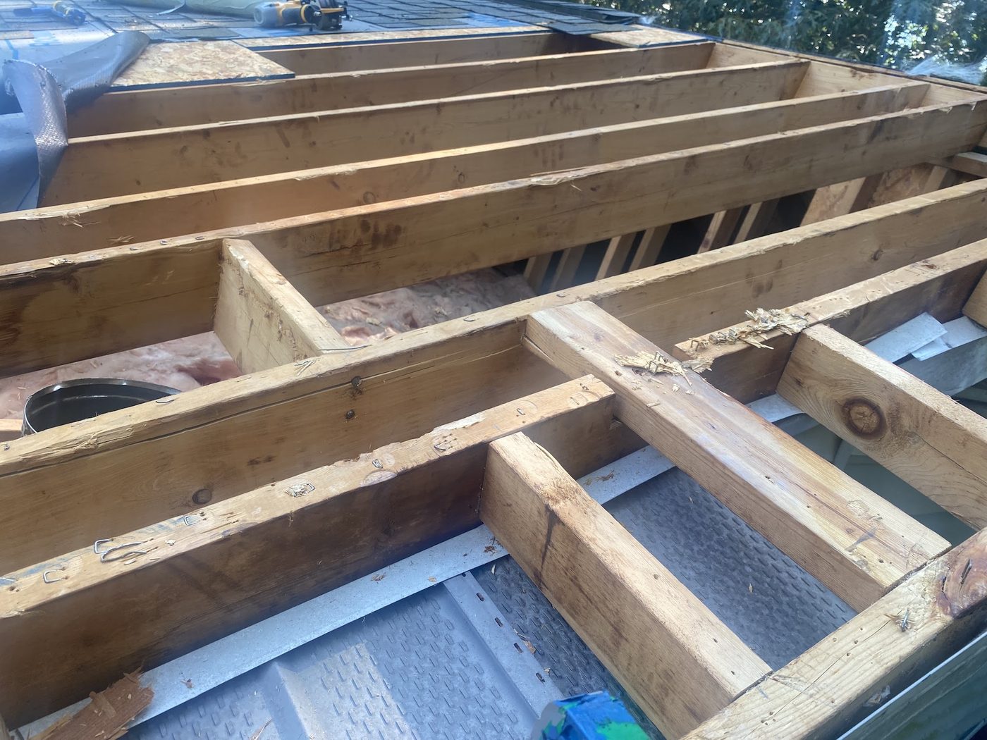 Exposed roof framing and joists during a structural roof repair