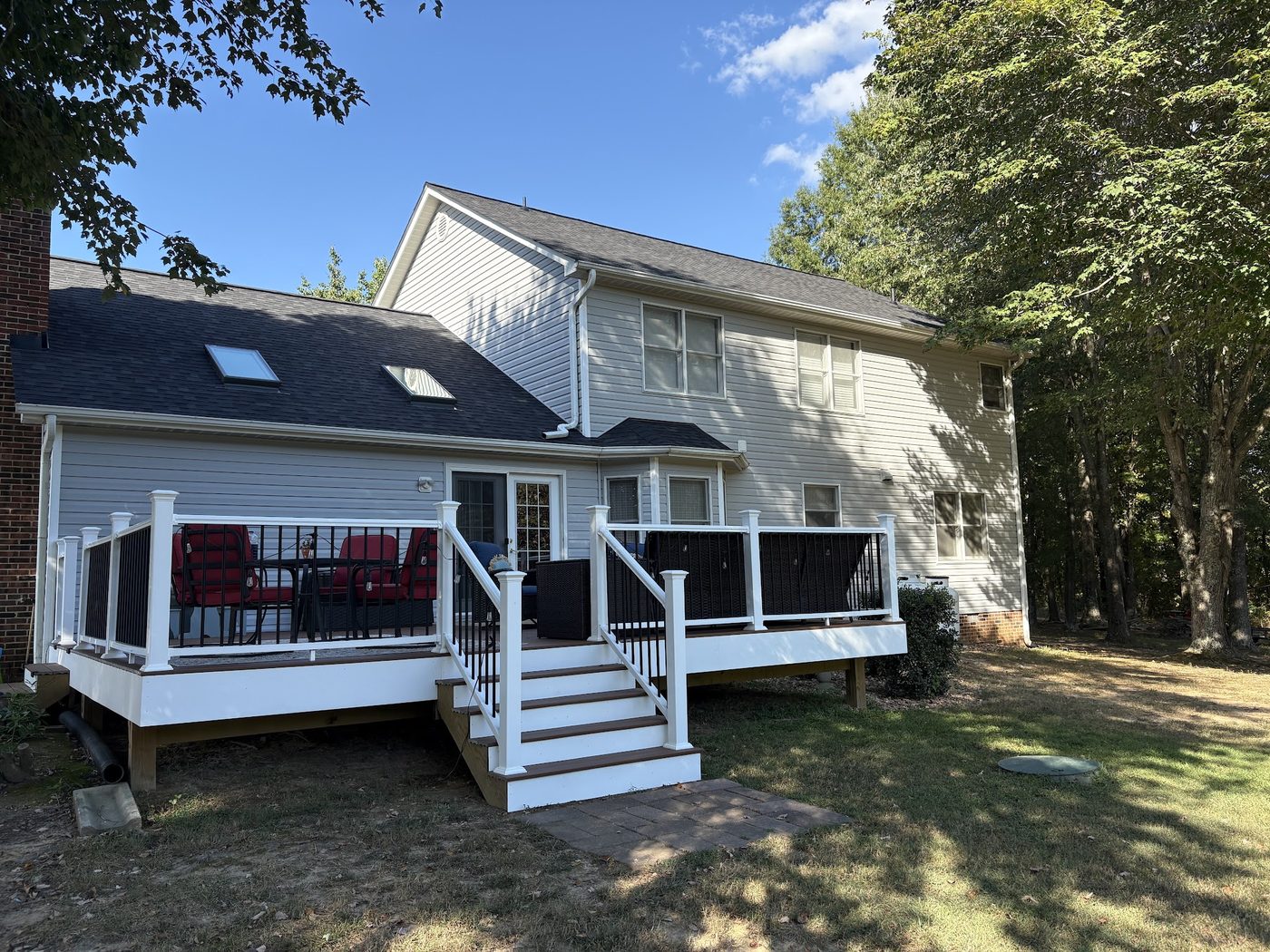 Two-story home with a new deck, gutters and downspouts