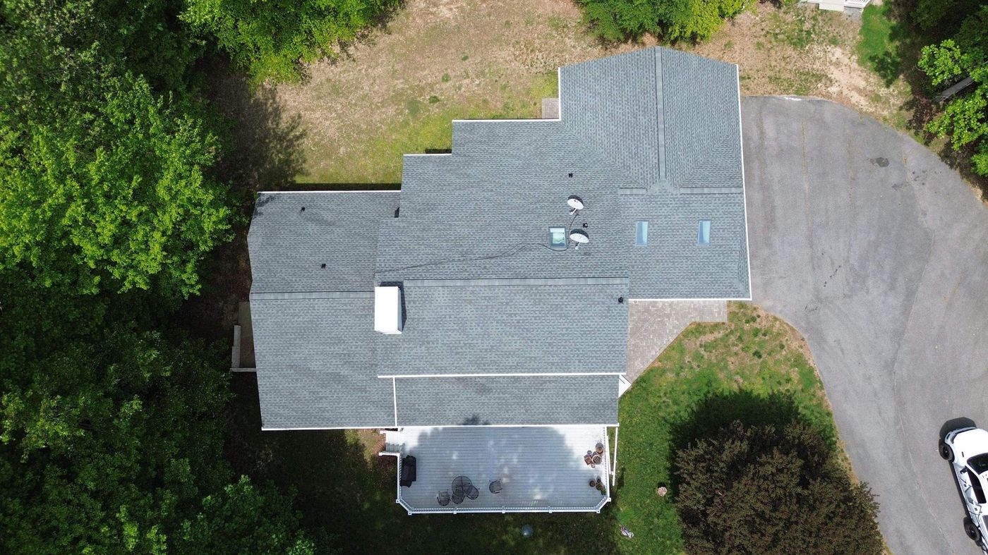 Drone view of a multi-level shingle roof on a suburban home