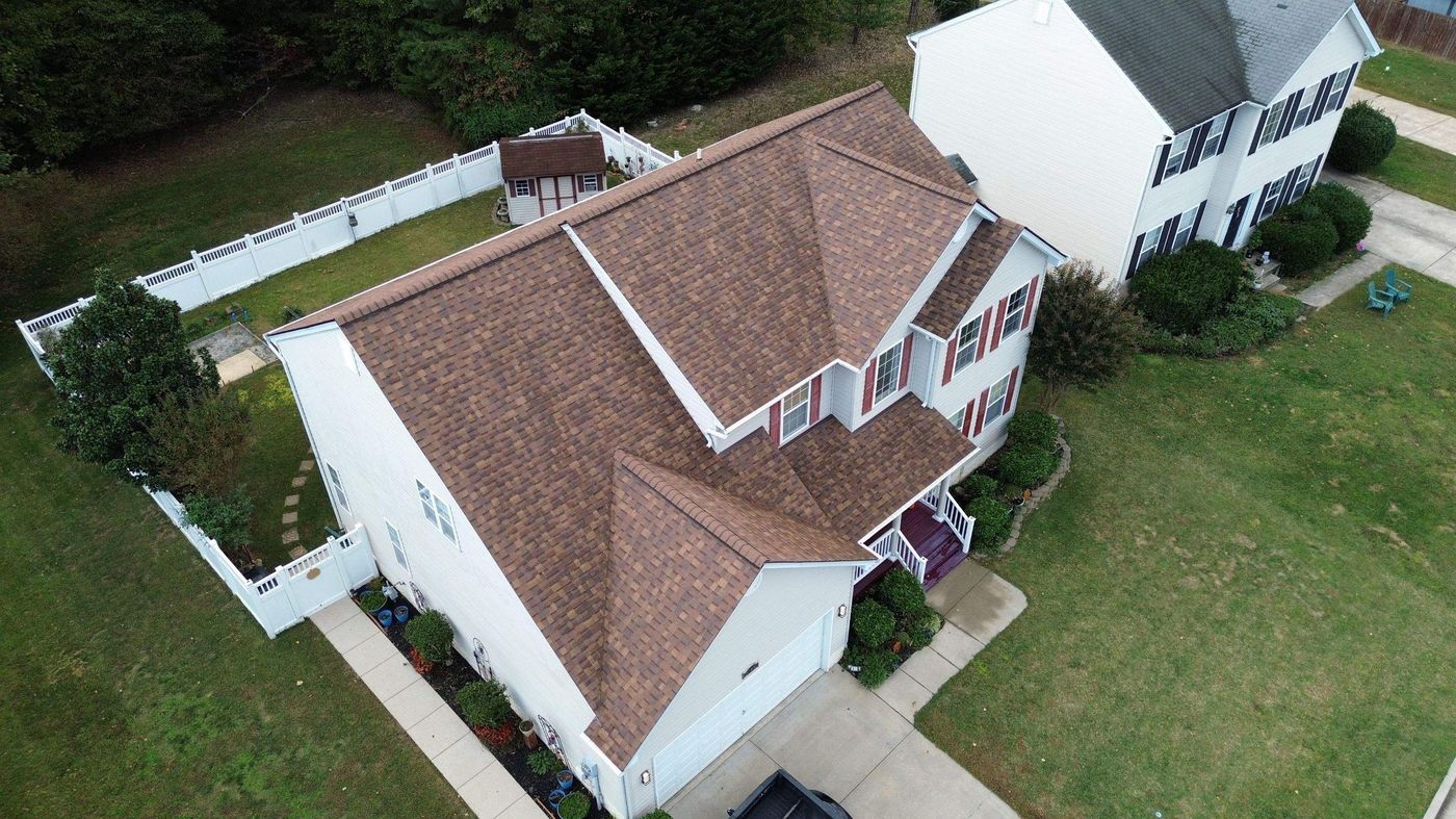 Aerial view of brown architectural shingles on a two-story colonial