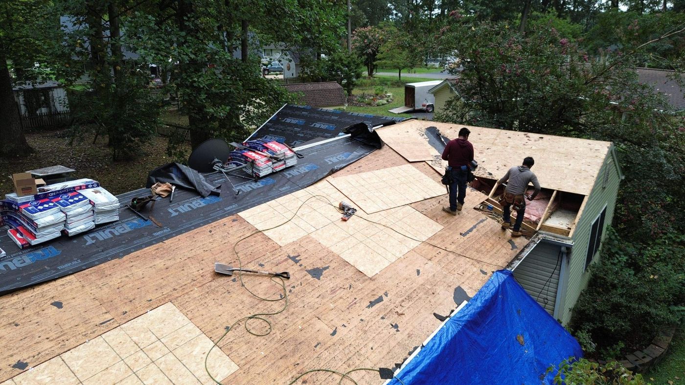 Roofers laying new decking during a tear-off