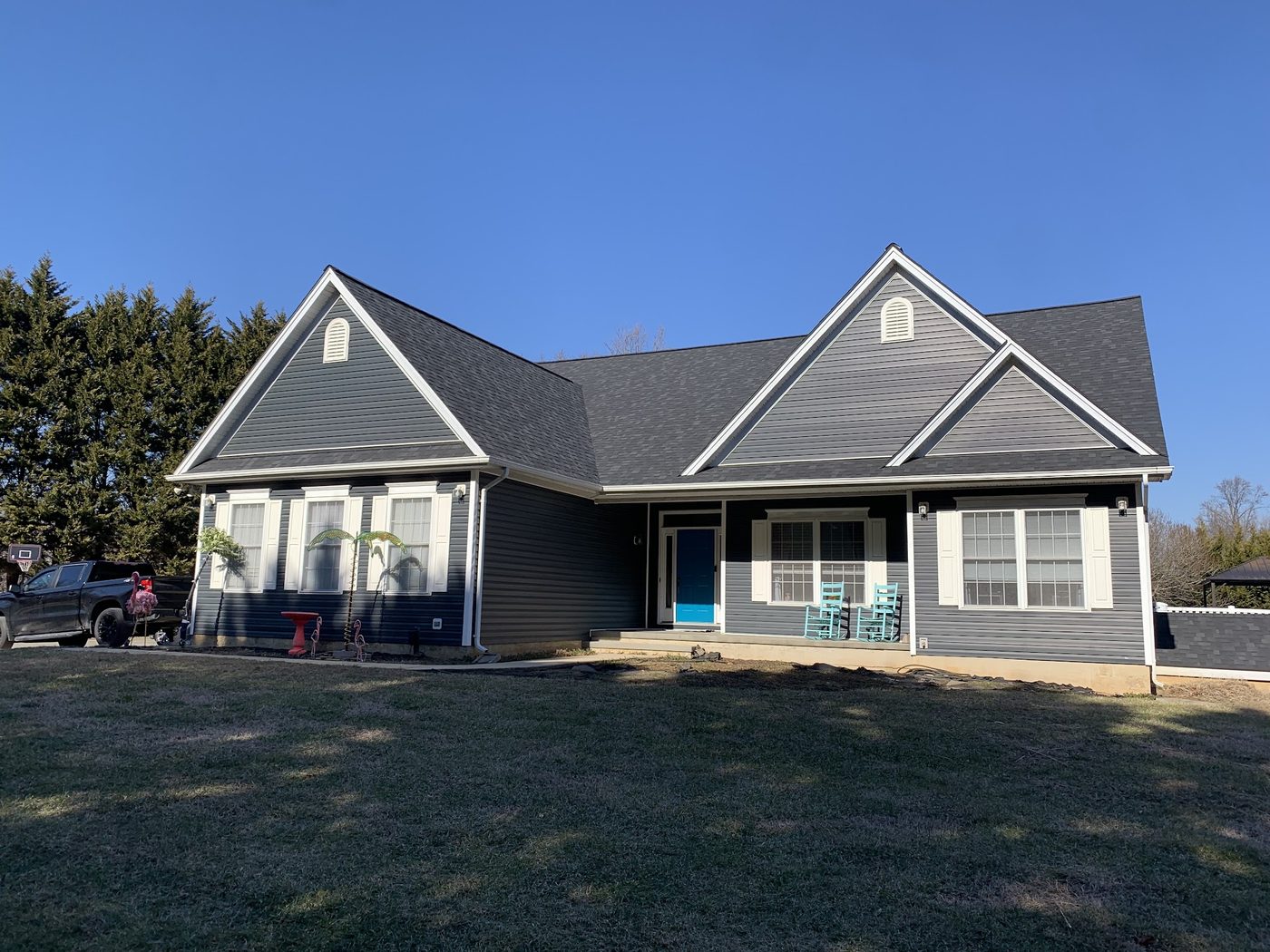 Blue-gray two-story home with a new dark shingle roof
