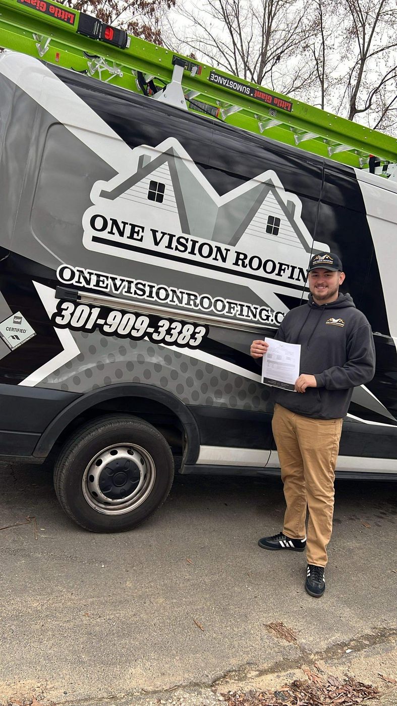 One Vision Roofing team member beside a branded company van